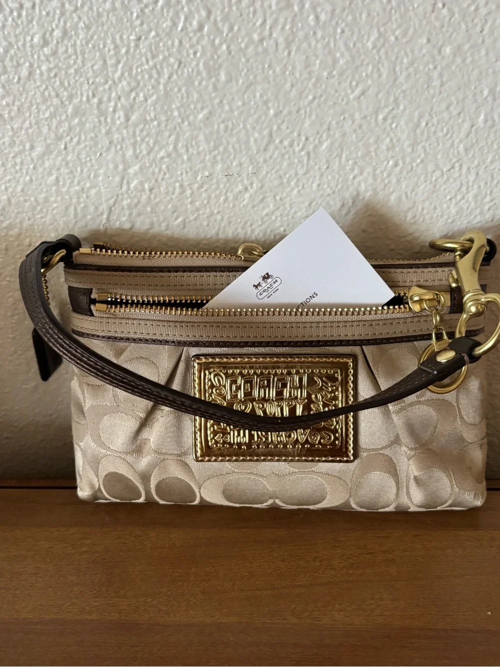 Coach Beige Signature Wristlet Pouch with Gold Logo Plaque